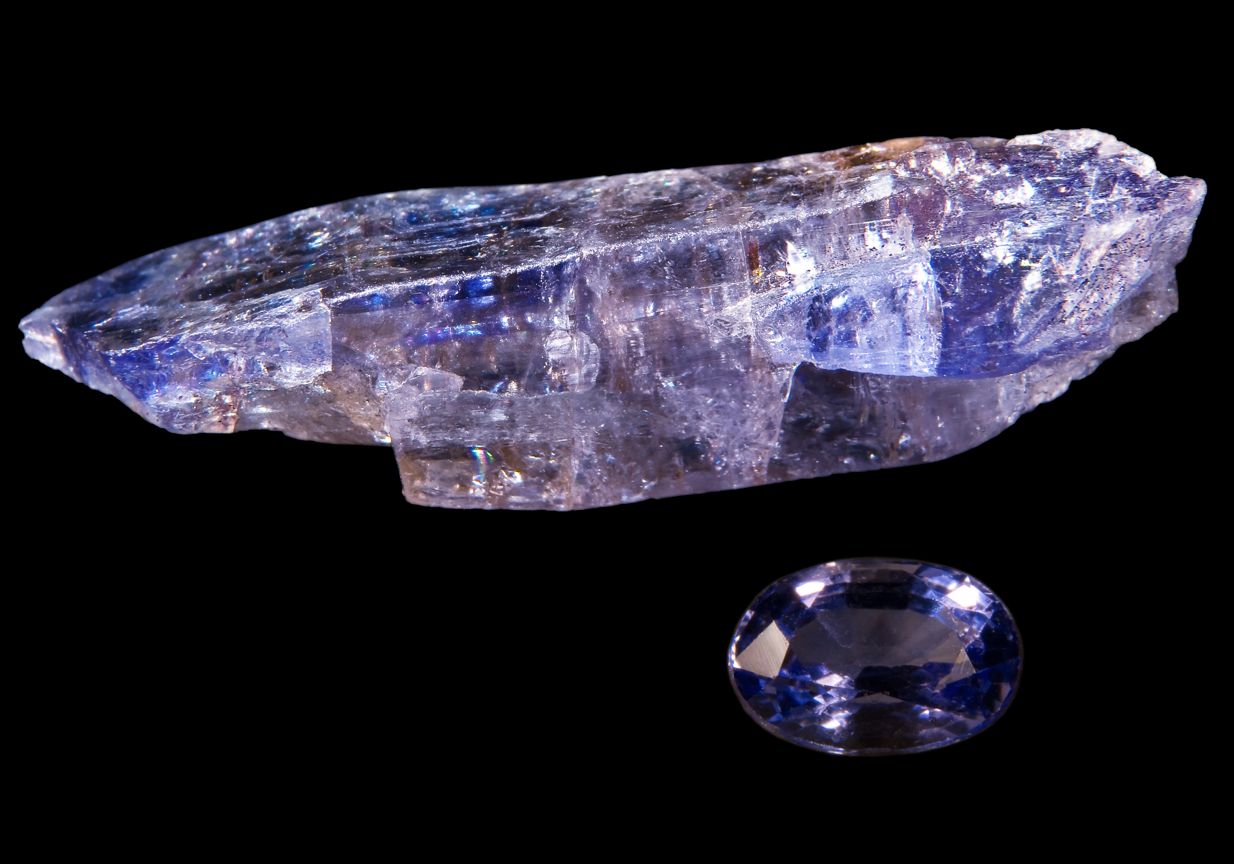 A raw tanzanite crystal and a cut gem